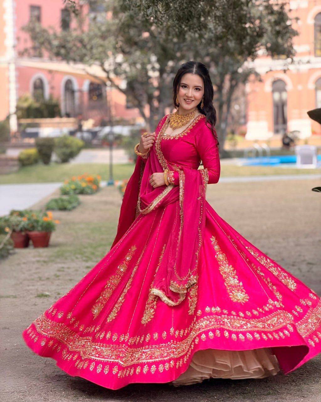Radiant Rani Pink Silk Lehenga Choli Adorned with Opulent Heritage Floral Motifs and Intricate Zari Borders